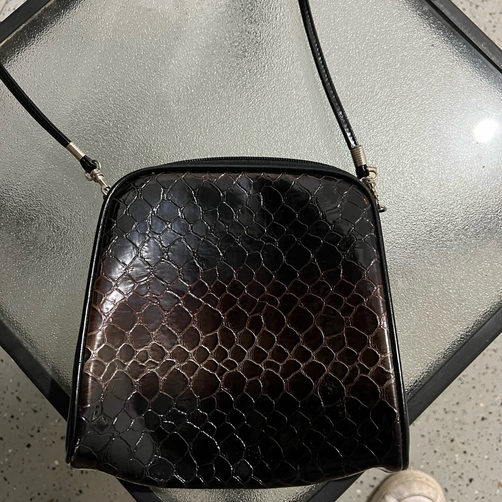 Black leather shoulder bag with silver hardware